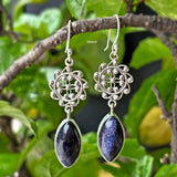 Close‑up of blue sunstone earrings in a floral (phool) silver setting