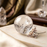 Clear Quartz gemstone sphere with natural internal patterns