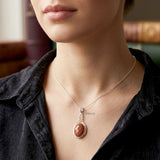 handcrafted knot silver pendant with golden gemstone