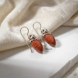 Marquise-shaped sterling silver earrings with golden sunstone-inspired stone