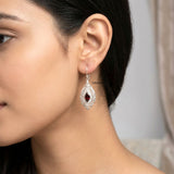Close-up of faceted marquise-shaped natural garnet silver earrings