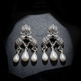 Traditional lotus elephant silver earrings with elegant pearl accents
