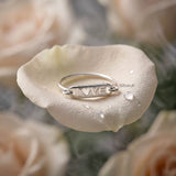 minimal silver love band ring worn on finger