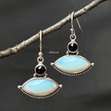 Close up of Opalite and natural Iolite gemstones set in 92.5 sterling silver earrings