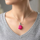 Round pink druzy pendant in polished sterling silver