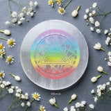 Round selenite charging plate engraved with Eye of Horus symbol