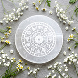 Round selenite crystal charging plate engraved with zodiac wheel