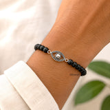 Natural ebony wood bracelet with sterling silver Evil Eye symbol for everyday wear.